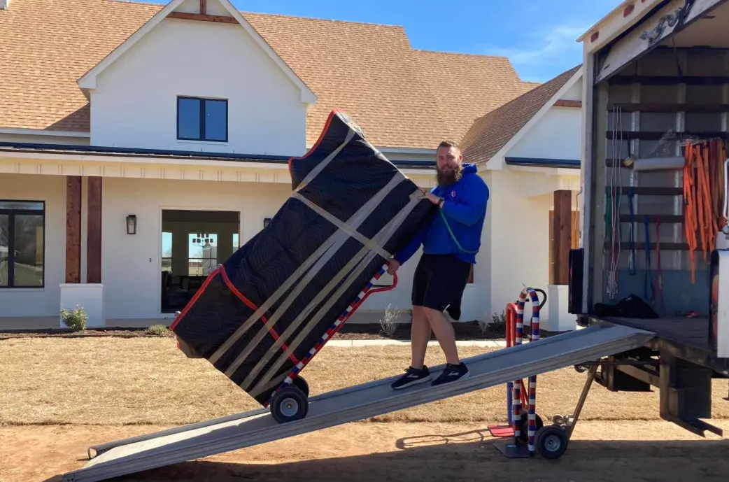 a member of Brazos Movers loading things into a truck for a long distance move